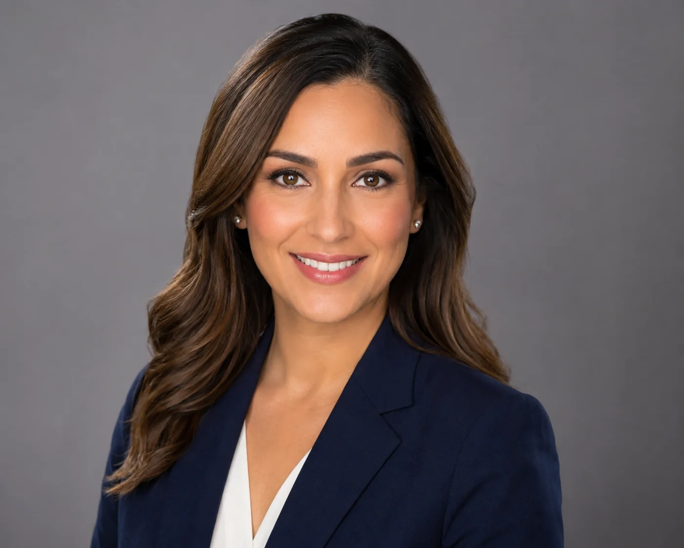 Woman in a solid color blazer with a clean neckline photographed under soft studio lighting